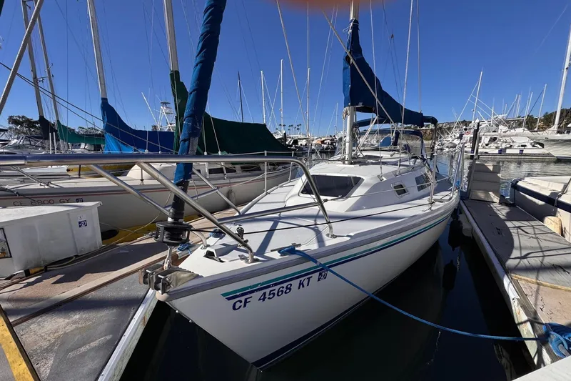 The Image of 1994 Catalina 270 sailboat docked at marina under clear blue sky. - 0