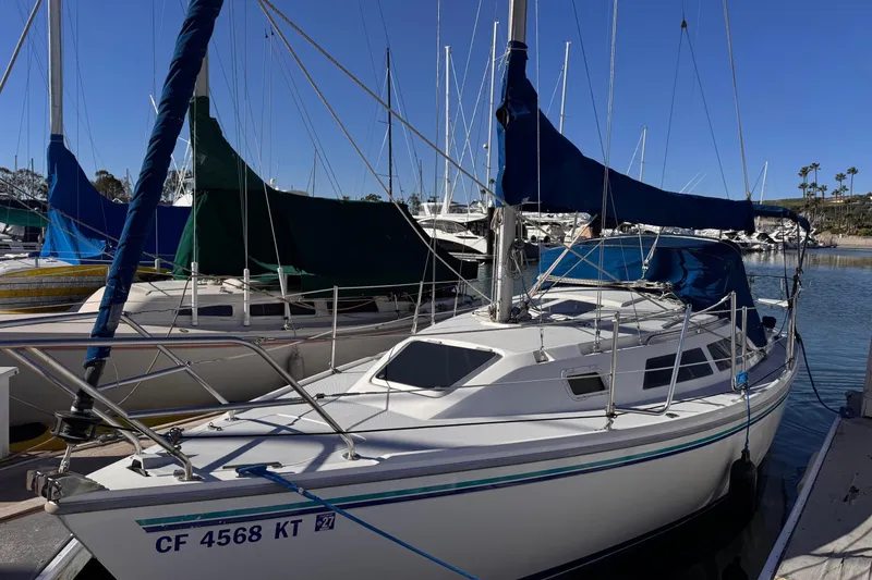 Slide: The Image of 1994 Catalina 270 sailboat docked in a marina under clear blue skies. - 1