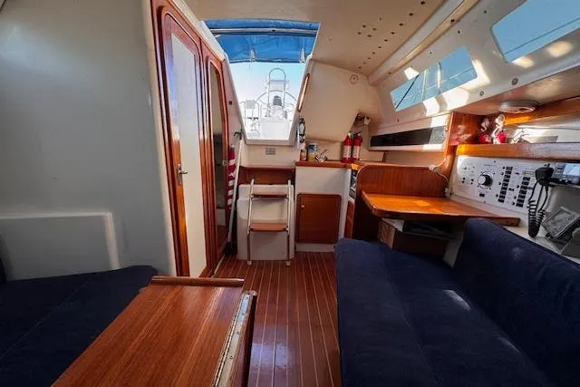 Slide: The Image of Interior of a 1994 Catalina 270 sailboat, featuring wood finishes and seating area. - 10
