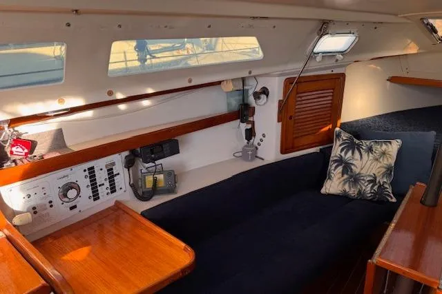 Slide: The Image of Interior of a 1994 Catalina 270 sailboat with cozy seating and nautical decor. - 12