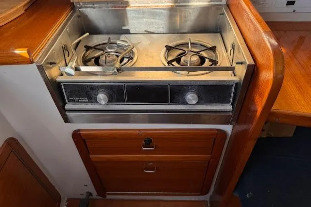 Slide: The Image of Stove in 1994 Catalina 270 sailboat galley with wooden cabinetry. - 14