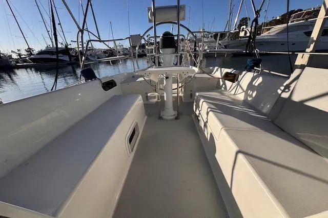Slide: The Image of 1994 Catalina 270 sailboat cockpit with seating, steering wheel, and marina view. - 5
