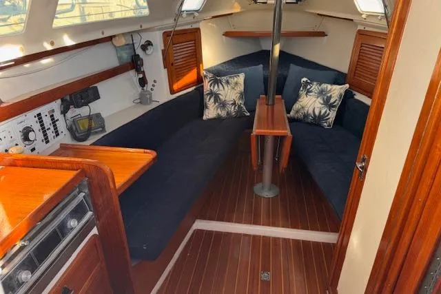 Slide: The Image of Interior of 1994 Catalina 270 sailboat with cozy seating and wooden finishes. - 9
