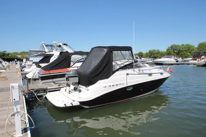The Image of 2004 Regal 2665 Commodore boat docked at marina on a sunny day. - 1