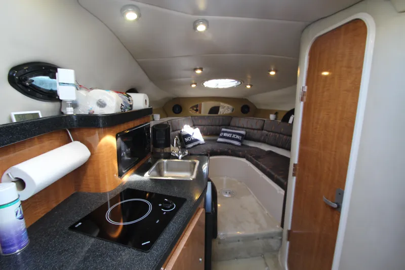 Slide: The Image of 2004 Regal 2665 Commodore interior with kitchenette and seating area. - 14