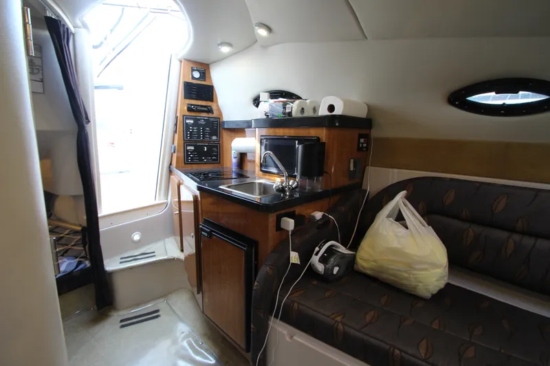 Slide: The Image of 2004 Regal 2665 Commodore cabin interior with kitchenette and seating area. - 21