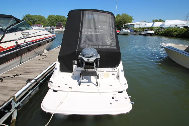 Slide: The Image of 2004 Regal 2665 Commodore boat docked at marina with black canopy. - 6