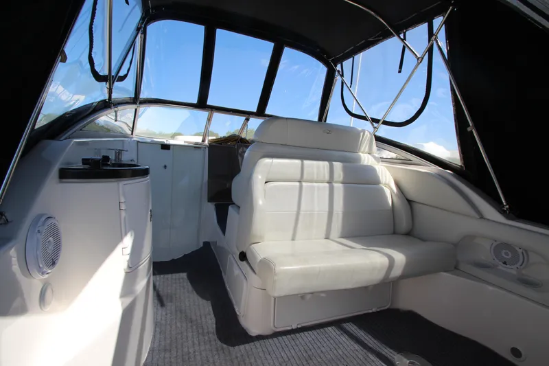 Slide: The Image of 2004 Regal 2665 Commodore boat interior with white seating and canopy. - 8