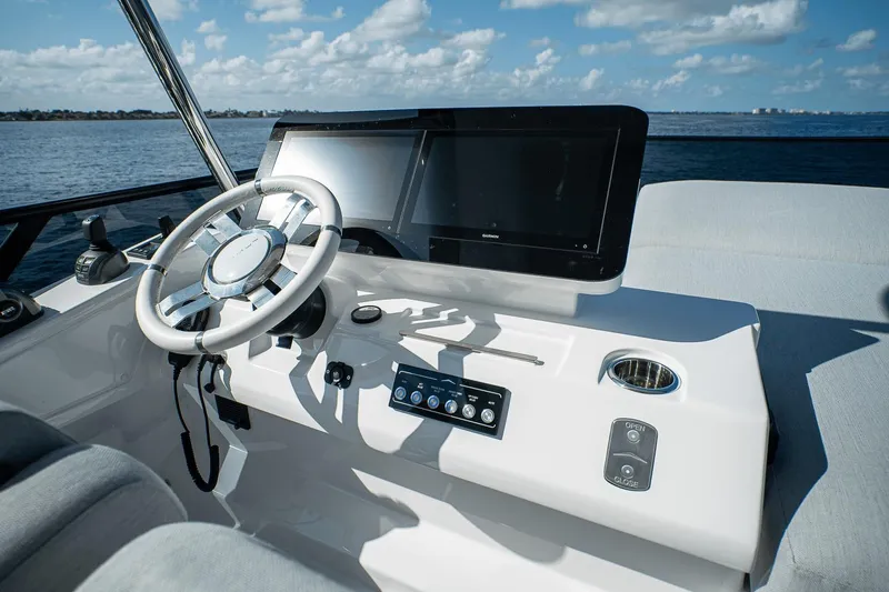 Slide: The Image of 2026 Azimut Fly 53 yacht helm with modern steering and navigation display. - 38