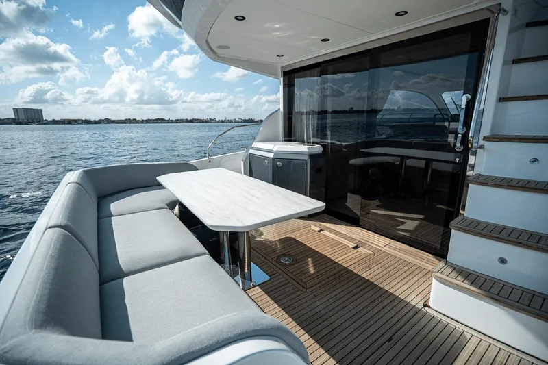 Slide: The Image of Luxury Azimut Fly 53 yacht deck with seating, table, and ocean view, 2026 model. - 6