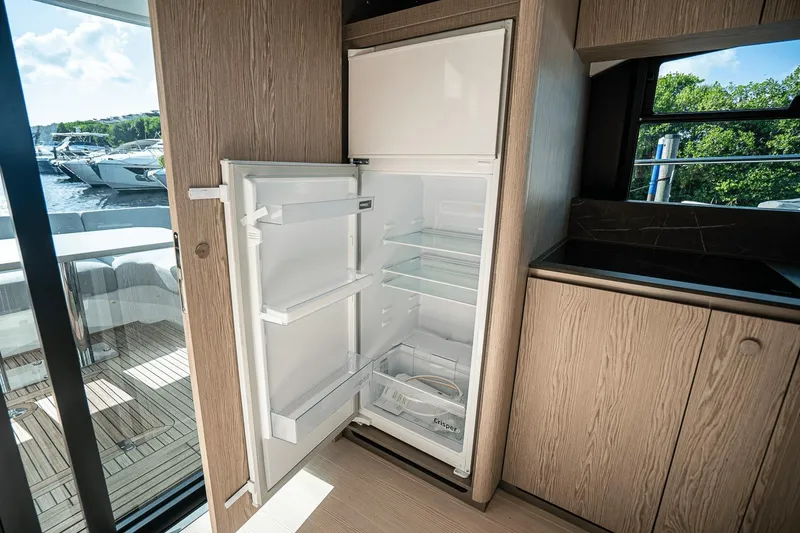 Slide: The Image of Open refrigerator in the modern kitchen of a 2026 Azimut Fly 53 yacht. - 9