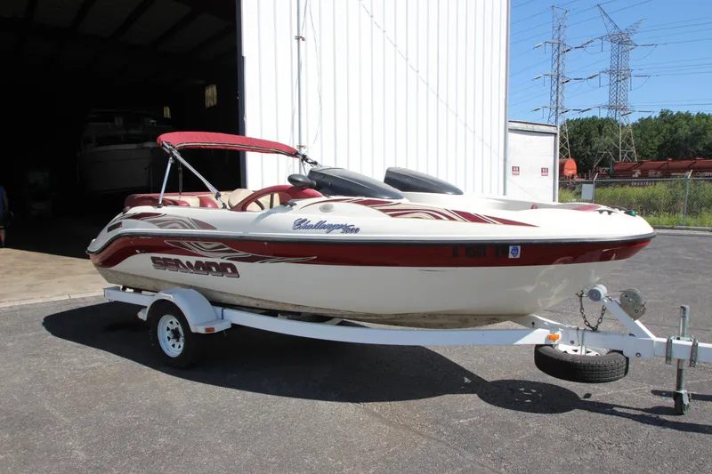 The Image of 2000 Bombardier Challenger 1800 boat on trailer outside a storage facility. - 1