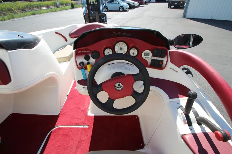 Slide: The Image of Interior of a 2000 Bombardier Challenger 1800 boat, featuring red and white dashboard. - 3