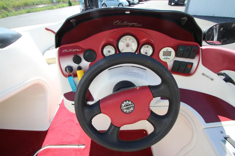 Slide: The Image of Steering wheel and dashboard of a 2000 Bombardier Challenger 1800 boat. - 4
