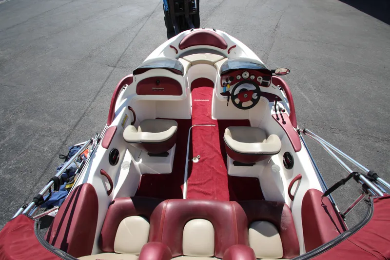 Slide: The Image of Interior of a 2000 Bombardier Challenger 1800 boat with red and white seating. - 7