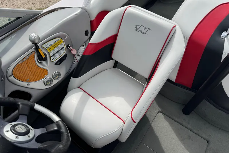 Slide: The Image of 2004 Correct Craft Air Nautique 216 Limited boat interior with steering wheel and seat detail. - 11