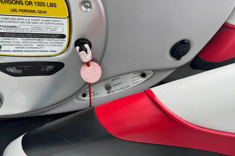 Slide: The Image of 2004 Correct Craft Air Nautique 216 Limited dashboard with safety and control labels. - 12