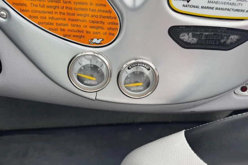 Slide: The Image of 2004 Correct Craft Air Nautique 216 Limited dashboard with water level gauges. - 13