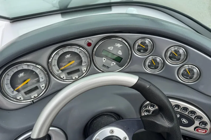 Slide: The Image of Dashboard of 2004 Correct Craft Air Nautique 216 Limited boat with gauges and steering wheel. - 15