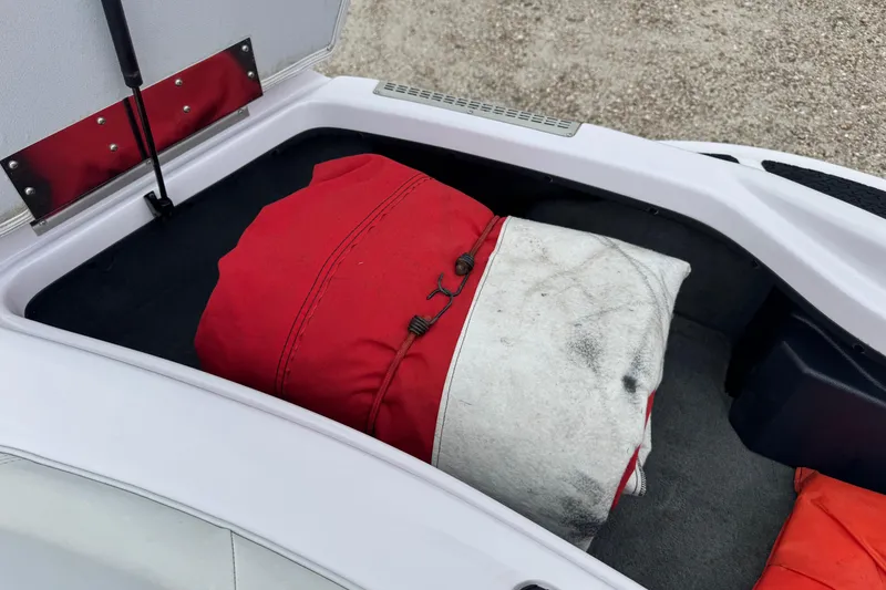 Slide: The Image of Open storage compartment in 2004 Correct Craft Air Nautique 216 Limited boat. - 19