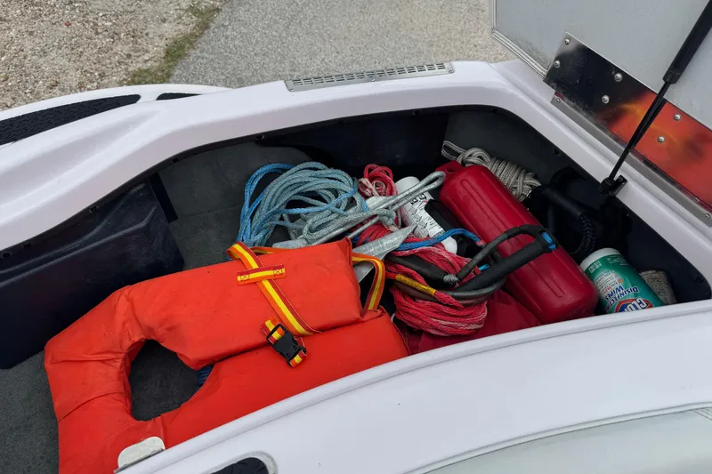 Slide: The Image of Storage compartment of 2004 Correct Craft Air Nautique 216 Limited with boating gear. - 20