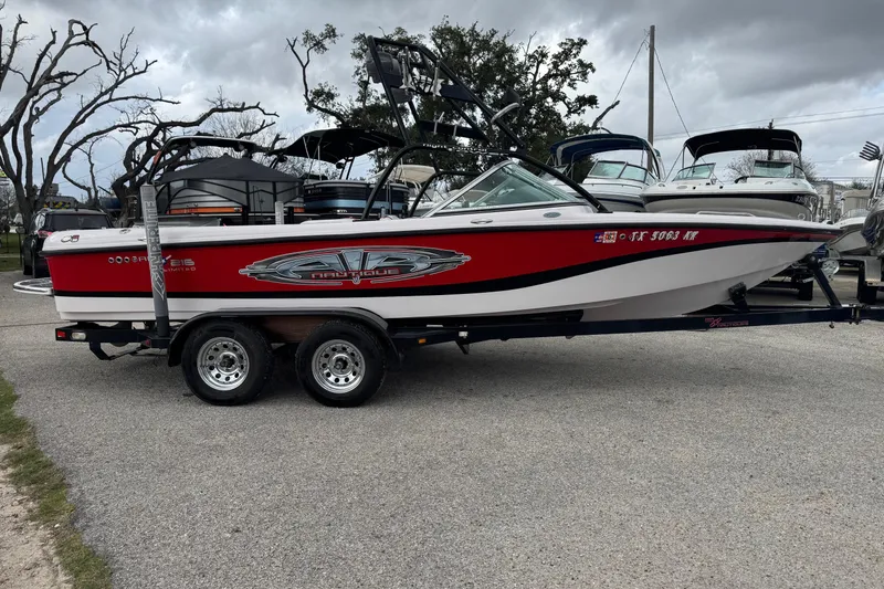 Slide: The Image of 2004 Correct Craft Air Nautique 216 Limited boat on trailer, parked outdoors. - 4