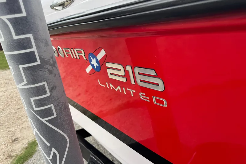 Slide: The Image of 2004 Correct Craft Air Nautique 216 Limited boat, red exterior with logo detail. - 5