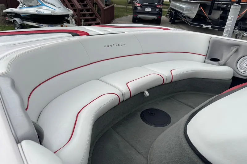 Slide: The Image of 2004 Correct Craft Air Nautique 216 Limited boat interior with white and red seating. - 6