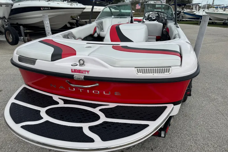 Slide: The Image of 2004 Correct Craft Air Nautique 216 Limited boat, red and white, rear view. - 7