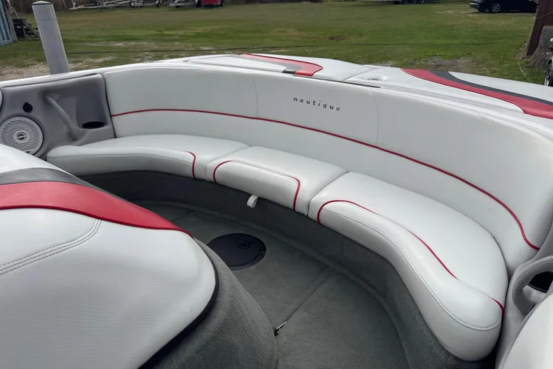 Slide: The Image of 2004 Correct Craft Air Nautique 216 Limited boat interior with white and red seating. - 8