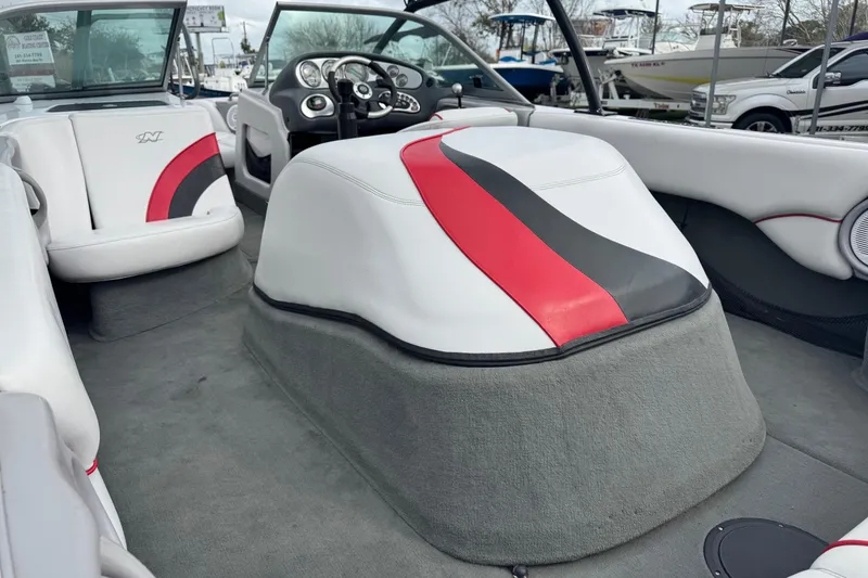 Slide: The Image of 2004 Correct Craft Air Nautique 216 Limited interior with red and black accents. - 9