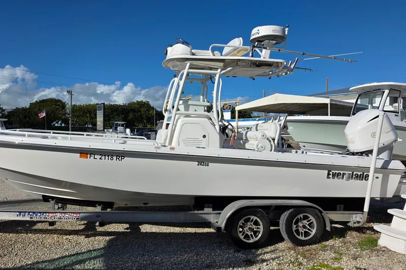 Slide: The Image of 2018 Everglades 243 Center Console boat on trailer under clear blue sky. - 3