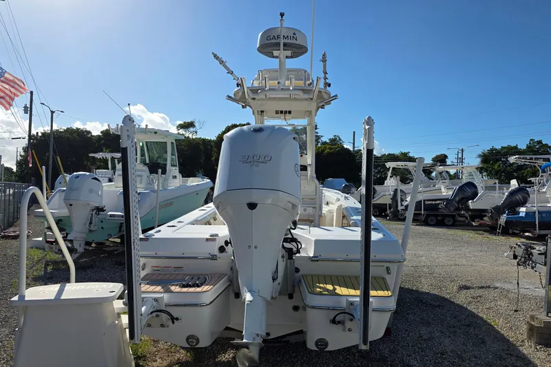 Slide: The Image of 2018 Everglades 243 Center Console boat with powerful outboard engine, parked outdoors. - 4