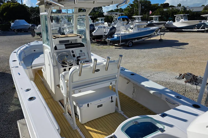 Slide: The Image of 2018 Everglades 243 Center Console boat with modern helm and seating in a marina. - 5