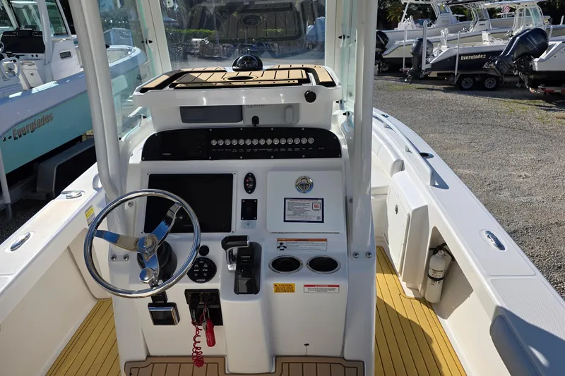 Slide: The Image of 2018 Everglades 243 Center Console boat interior with steering wheel and control panel. - 8