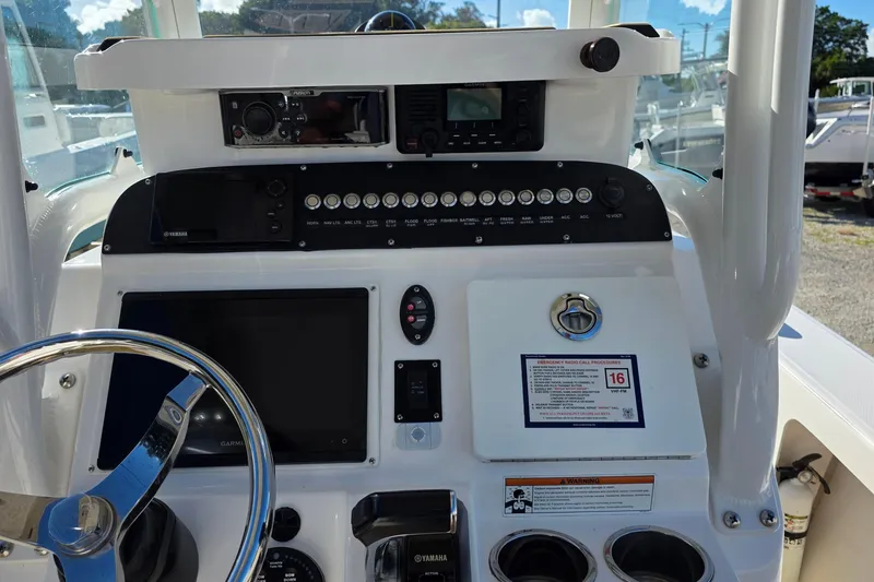Slide: The Image of 2018 Everglades 243 Center Console boat dashboard with steering wheel and control panel. - 9