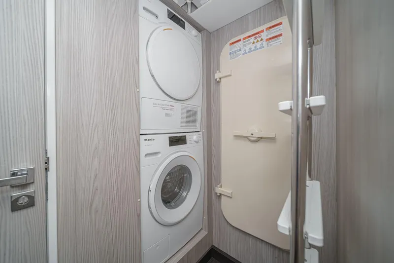 Slide: The Image of Laundry area with stacked washer and dryer on Azimut Fly 72 yacht, 2026 model. - 22