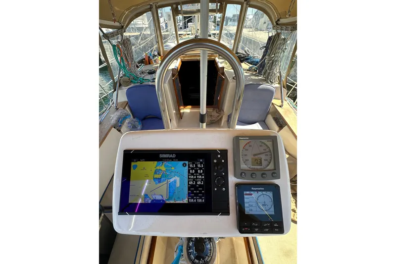 Slide: The Image of Cockpit of 1991 Island Packet 35 sailboat with navigation instruments and steering wheel. - 11