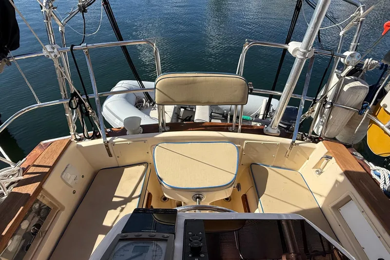 Slide: The Image of Cockpit of 1991 Island Packet 35 sailboat with seating and nautical equipment. - 12