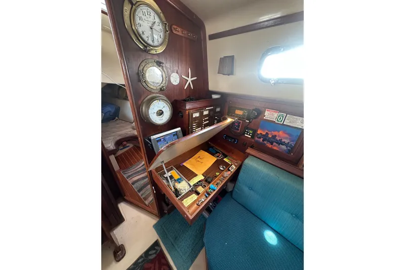 Slide: The Image of 1991 Island Packet 35 sailboat interior with navigation station and nautical instruments. - 22