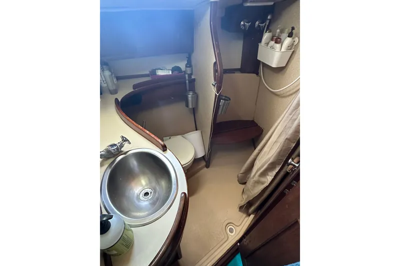 Slide: The Image of 1991 Island Packet 35 yacht bathroom with sink, toilet, and shower area. - 30