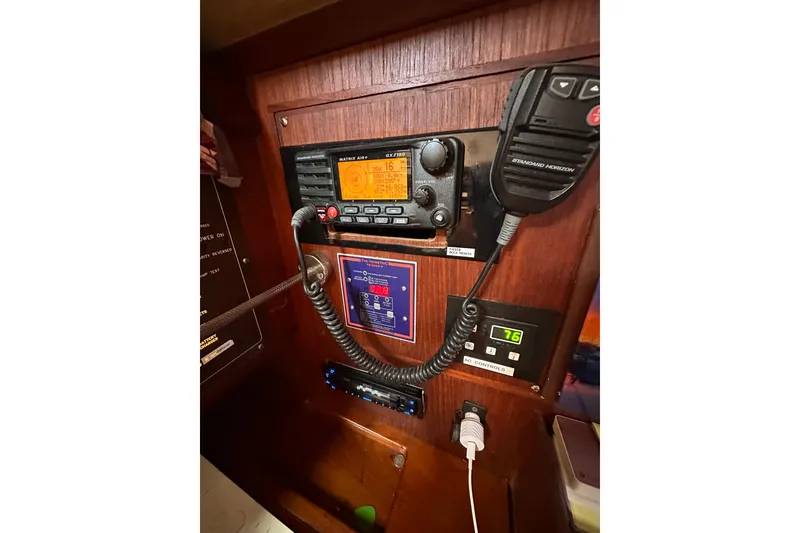 Slide: The Image of 1991 Island Packet 35 yacht radio and control panel with communication equipment. - 36