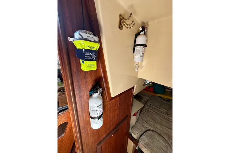 Slide: The Image of 1991 Island Packet 35 interior with safety equipment and fire extinguishers. - 37