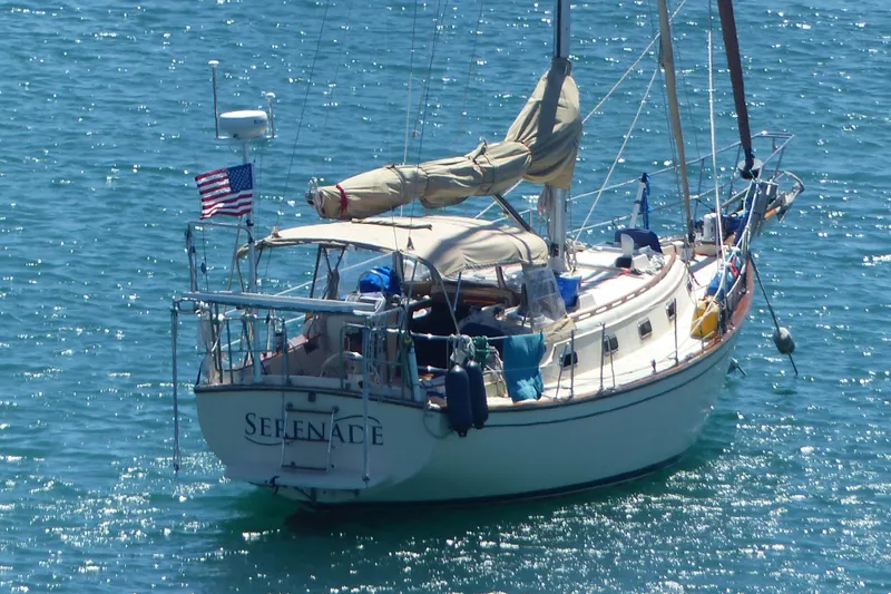 Slide: The Image of Sailboat "Serenade" on water, 1991 Island Packet 35, with American flag. - 43