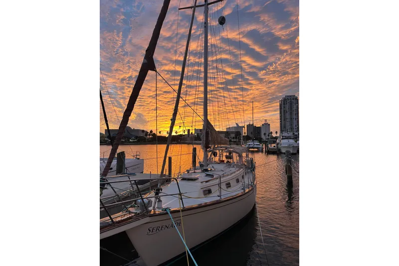 Slide: The Image of Sailboat Island Packet 35, 1991 model, docked at sunset with vibrant sky. - 45