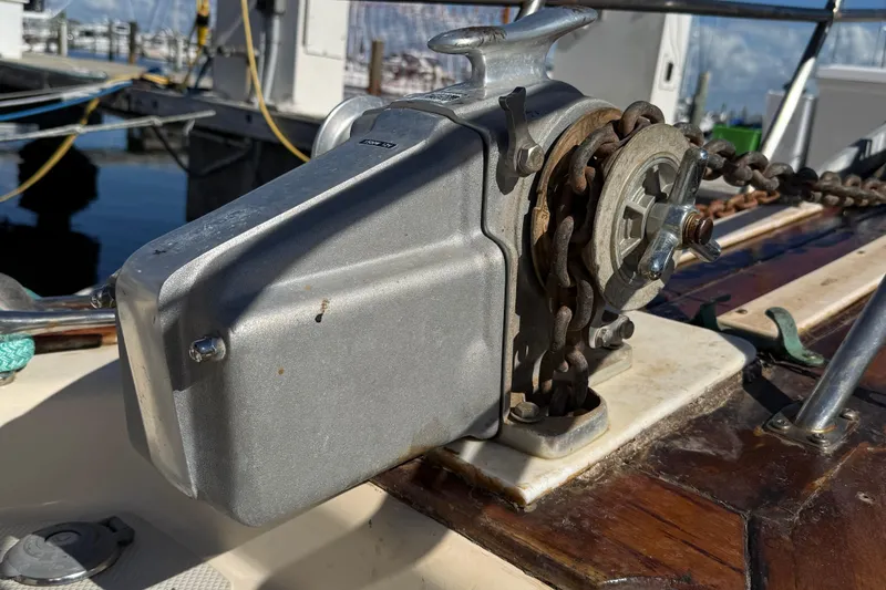 Slide: The Image of Anchor windlass on 1991 Island Packet 35 sailboat, docked with visible chain and deck details. - 6