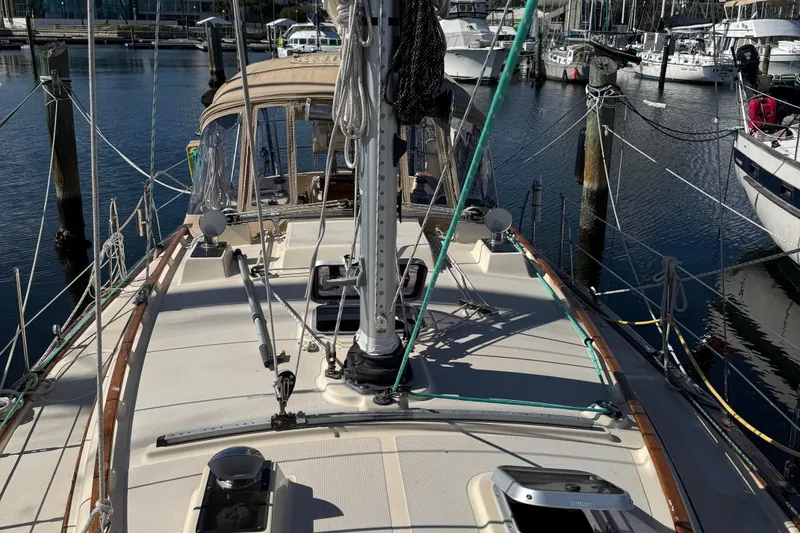Slide: The Image of 1991 Island Packet 35 sailboat docked at marina, showcasing deck and rigging. - 7