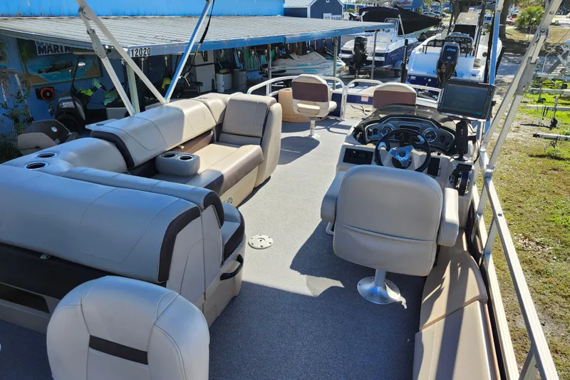 Slide: The Image of 2018 Sun Tracker Fishin' Barge 22 DLX interior with seating and steering console. - 12