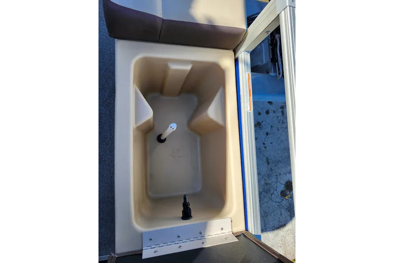 Slide: The Image of 2018 Sun Tracker Fishin' Barge 22 DLX livewell interior with seating and storage. - 15