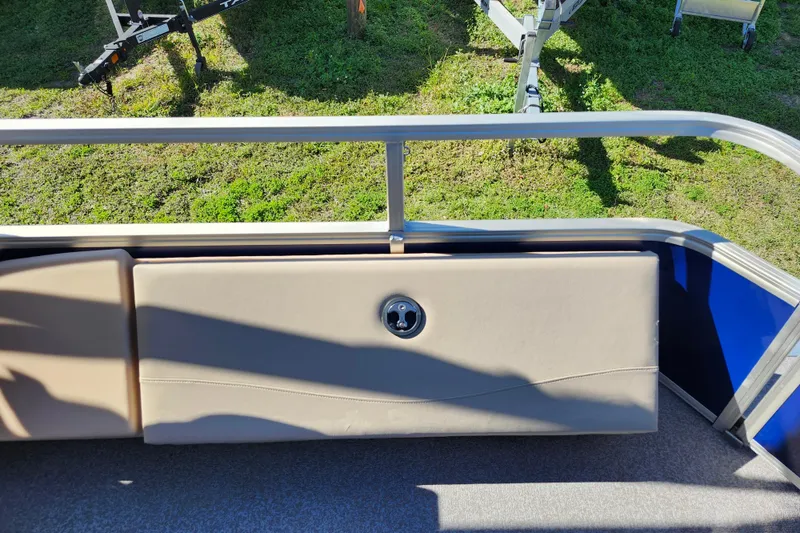 Slide: The Image of 2018 Sun Tracker Fishin' Barge 22 DLX interior with beige seating and railing. - 17